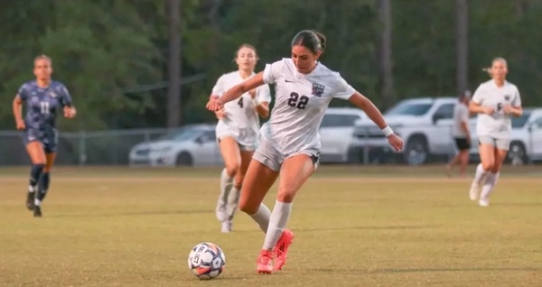 Knights' women' soccer controls the ball on the field during a match against ABAC.
